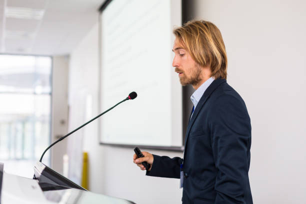 istock Handsome young man giving a speech at a conference 1206813593
