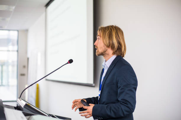 istock Handsome young man giving a speech at a conference 1206813612