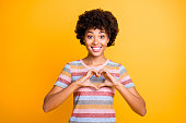 Close-up portrait of her she nice attractive lovely cheerful cheery funny girlish wavy-haired girl showing heart gesture isolated over bright vivid shine vibrant yellow color background