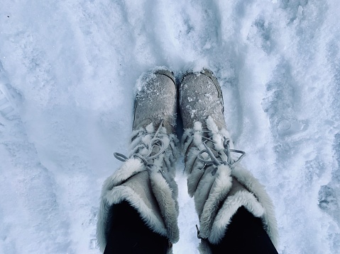 Furry boots in snow.