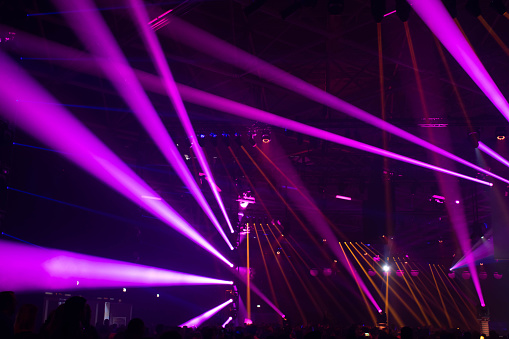 Scene, stage lights with colored spotlights and smoke, laser lights background, pink, purple, violet