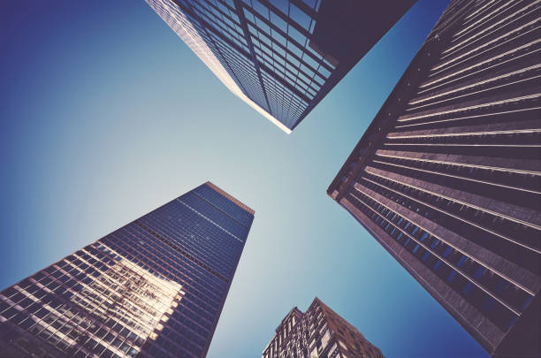 istock Looking up at Manhattan skyscrapers against the sun. 1206816892