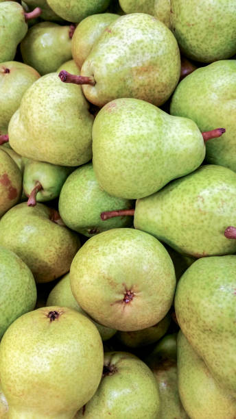 istock Whole ripened pears pile up in a stall for sale 1206817485