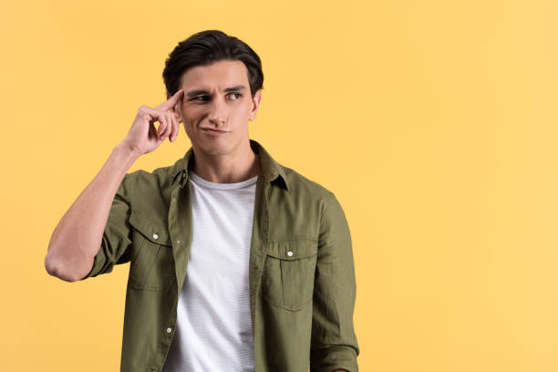 istock skeptical brunette young man thinking isolated on yellow 1206820518