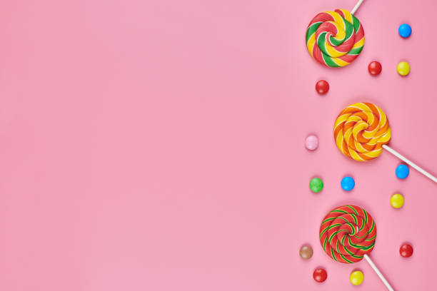 istock Sweet lollipops and candy on pink background 1206820700