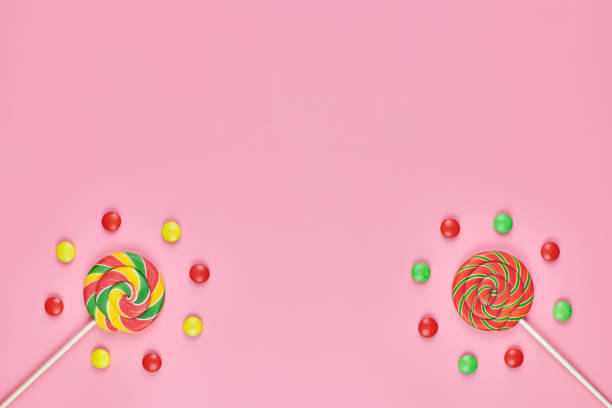 istock Sweet lollipops and candy on pink background 1206820831