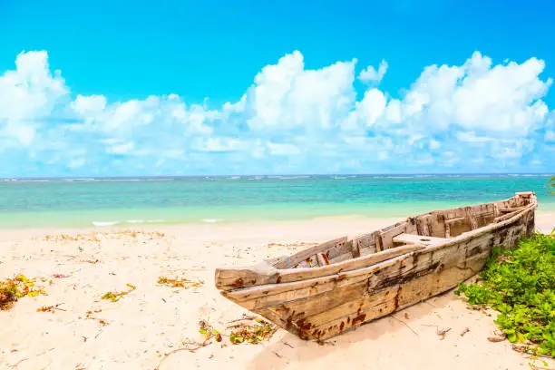 Beautiful tropical coast with wooden fishermans boat on Diani beach in Ukunda Kenya, Africa.