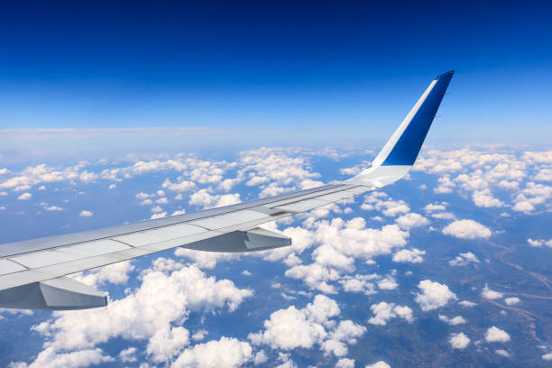 istock Airplane flying at high altitude and beautiful high-altitude clouds in spring 1206822412