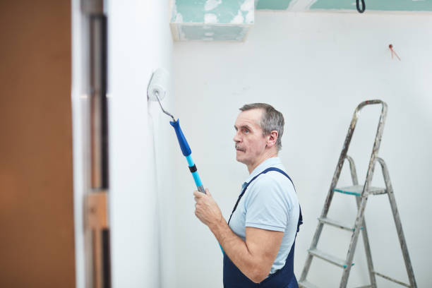 istock Senior Man Painting Walls 1206823599