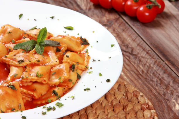 istock Ravioli Pasta with Tomato Sauce sprinkled with Spinach Mint and Basil 1206823717