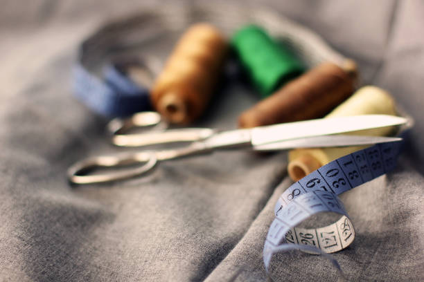 istock Sewing. Spools of thread on the fabric. Threads. Meter and scissors 1206823858