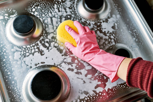 Woman is cleaning oven. Woman is cleaning oven. cleaning stove domestic kitchen human hand stock pictures, royalty-free photos & images