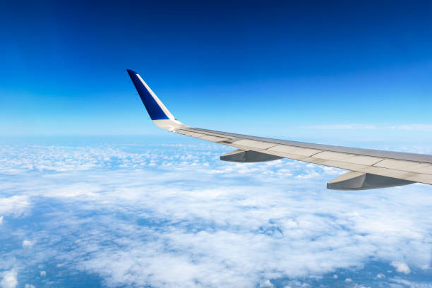 istock Airplane flying at high altitude and beautiful high-altitude clouds in spring 1206827355