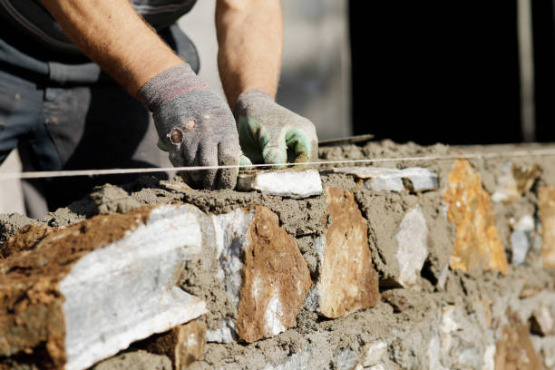 istock Close-up of construction worker builds stone wall 1206829123