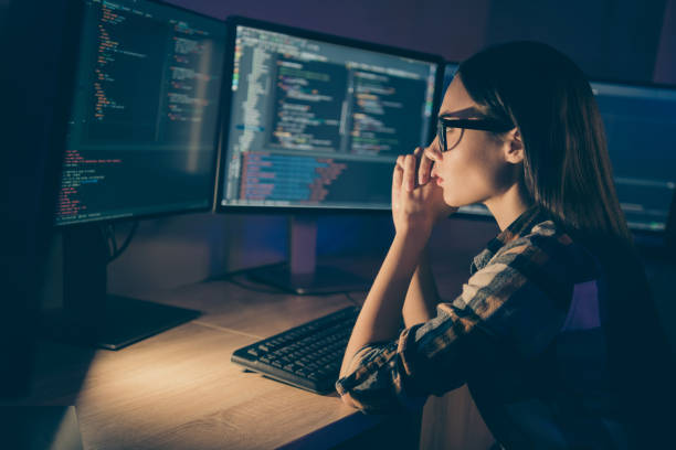 istock Photo of serious concentrated smart clever developer writing code for new video game to be released soon having to complete deadlines till morning 1206829617