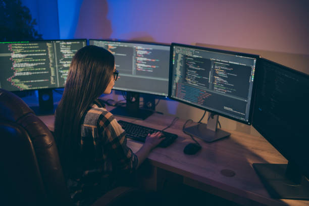 istock Photo of focused concentrated serious programmer searching for mistakes errors in code to debug and solve them 1206829842