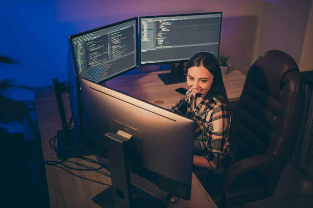 istock Photo of hard-working software developer in headset smiling toothily looking into screen using connection programs to speak 1206829911