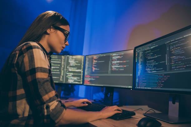 istock Photo of focused concentrated serious programmer looking through code of artificial intelligence to be debugged 1206829954
