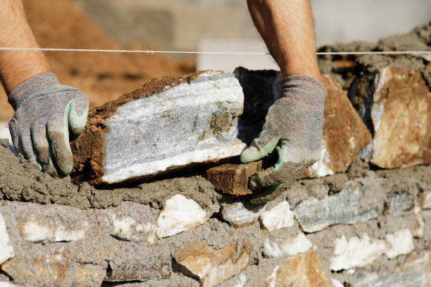istock Close-up of construction worker builds stone wall 1206830138