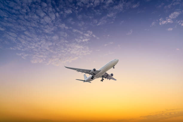 istock High-altitude airplane and beautiful sky at dusk 1206830520