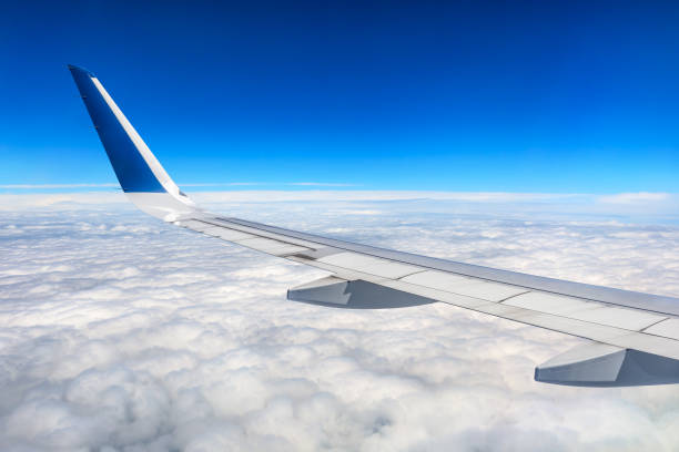 istock Airplane flying at high altitude and beautiful high-altitude clouds in spring 1206830707