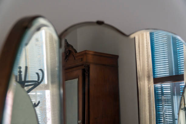 istock Three Sided Antique Mirror Reflects Items From An Old Bedroom 1206831732