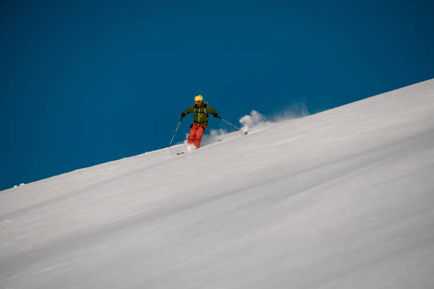 istock Brave freerider slides down on the mountain side 1206835499