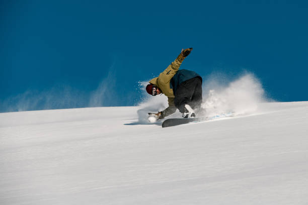 istock Male snowboarder slides down on the mountain side 1206835519