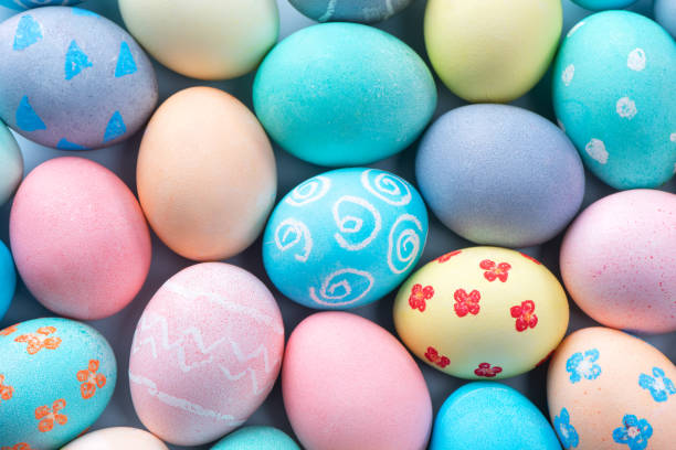 istock Colorful Easter eggs dyed by colored water with beautiful pattern on a pale blue background, design concept of holiday activity. 1206835688