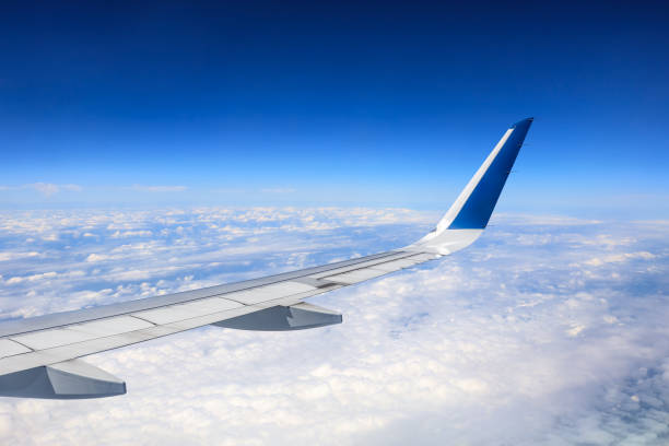 istock Airplane flying at high altitude and beautiful high-altitude clouds in spring 1206835842
