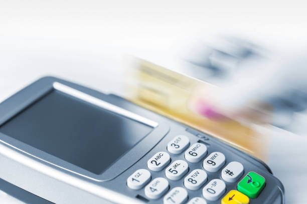 istock Swipe a card through a banking terminal 1206835871