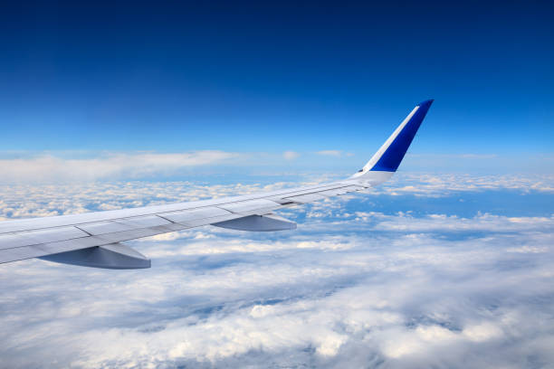 istock Airplane flying at high altitude and beautiful high-altitude clouds in spring 1206836317