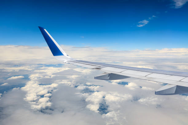 istock Airplane flying at high altitude and beautiful high-altitude clouds in spring 1206836381