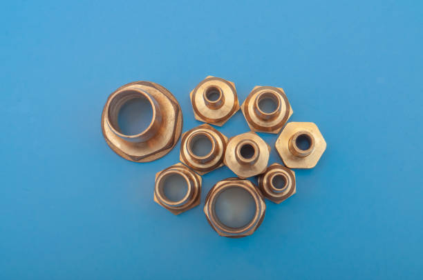Brass adapters of different diameters, to connect the hose and thread. Water supply equipment. A close-up photo of a blue background with a copy spase.