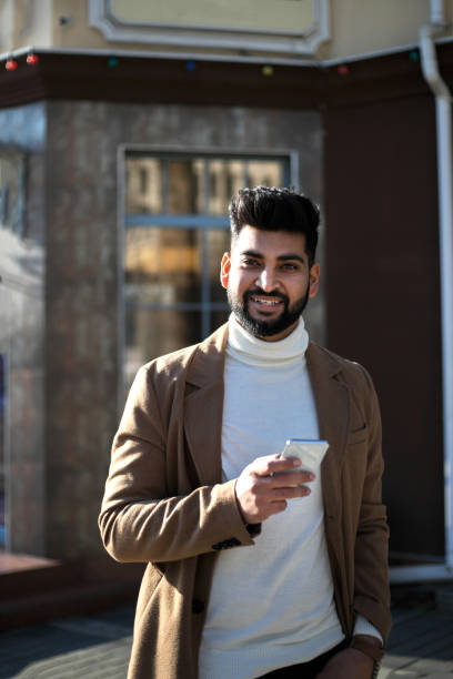 istock Young Indian businessman talking on smartphone and smiling. 1206837474