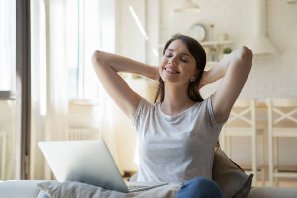 istock Young woman stretch in chair distracted from computer work 1206837790