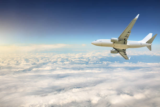istock Airplane flying at high altitude and beautiful high-altitude clouds in spring 1206837817