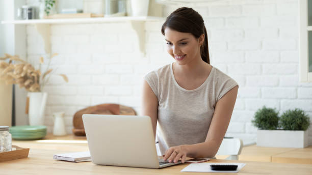 istock Young woman pay household bills using modern laptop 1206837894