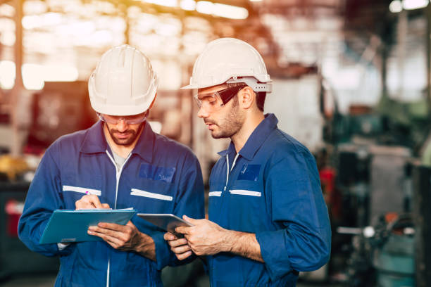 istock Engineer teamwork cooperate with worker to checking factory machine for safety and talking together. 1206839481