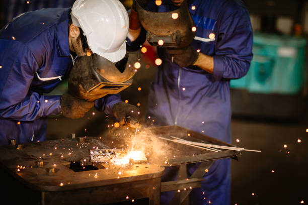 industry worker tig welding steel with safety mask for protect eyesight in metal factory. industry worker tig welding steel with safety mask for protect eyesight in metal factory. metal worker photos stock pictures, royalty-free photos & images