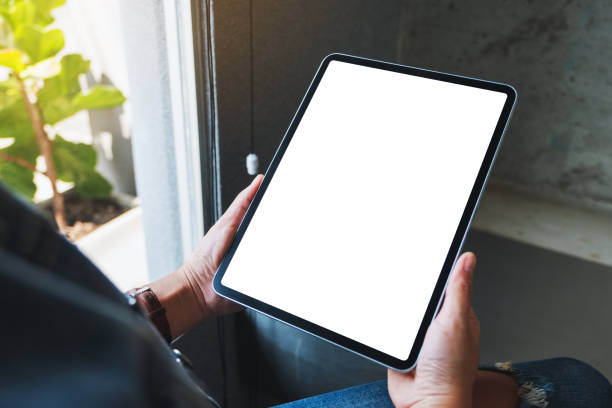 istock a woman holding black tablet pc with blank white screen in cafe 1206843306