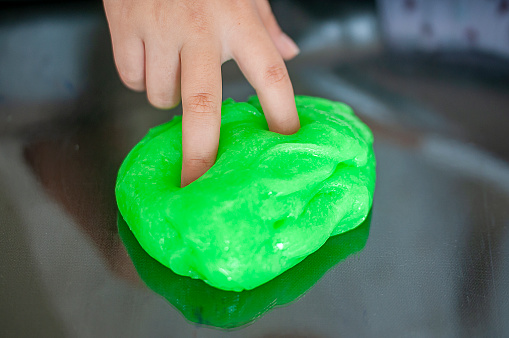Hand holding homemade toy called slime