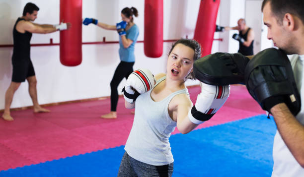 istock Sportswomen competing in colored boxing gloves 1206847533