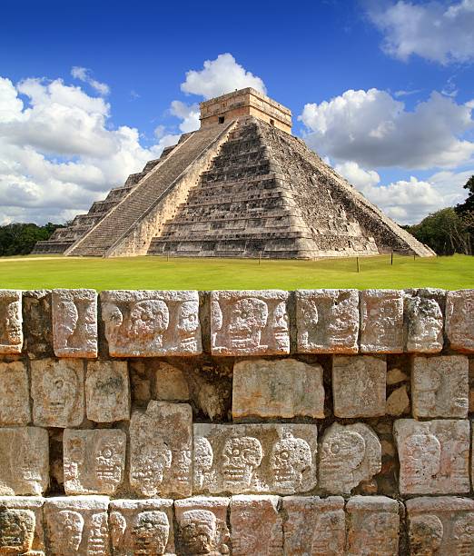 Landscape of Chichen Itza Tzompantli, The Wall of Skulls Chichen Itza Tzompantli the Wall of Skulls and Kukulkan pyramid kukulkan pyramid photos stock pictures, royalty-free photos & images