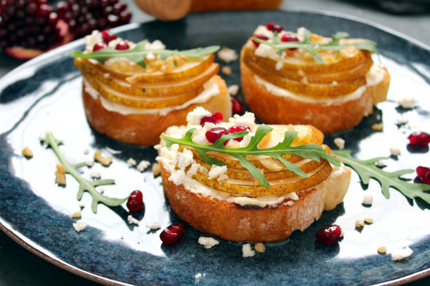 istock Crostini with pear, feta cheese, honey, nuts and pomegranate. 1206851230