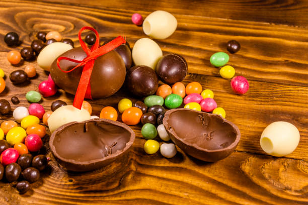 istock Chocolate easter eggs and multicolored candies on wooden table 1206851627