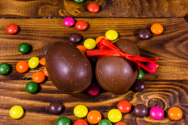 istock Chocolate easter eggs and multicolored candies on wooden table 1206851659