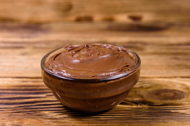 istock Glass bowl with chocolate spread on a wooden table 1206852277