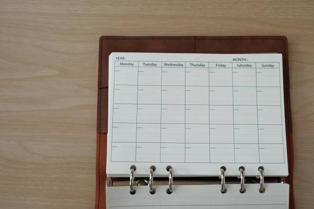 istock Blank form day schedule in diary book on wooden table 1206852783