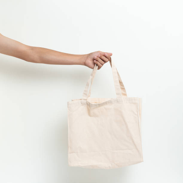 istock Hand man holding bag canvas fabric blank for mockup isolated on white background. 1206854802